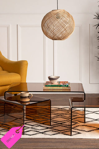 Beautiful amber coffee tables in a living room setting styled with warm amber accessories, rugs and candlesticks etc. 