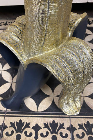 Detail of the gold peel of the Banana Side Table. The banana itself is a black hue.