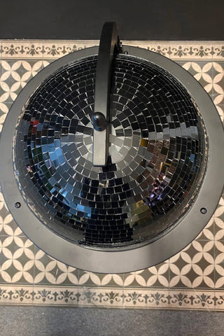 The top of the outlet black disco ball trolley. The image shows gluing imperfections and gaps between the mirror ball tiles.