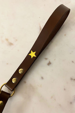 Detail of the brown leather handle and the star and stud detailing on the Nearly Perfect Brown Leather Dog Lead