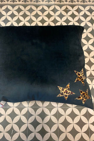 Beautiful black dog bed with the three bold leopard stars on the bottom right hand side of the bed.