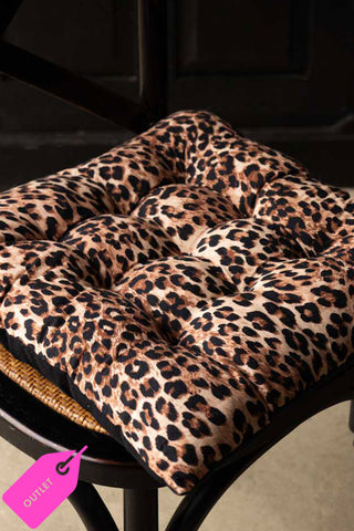 The Leopard Print Seat Cushion styled on a dining chair.