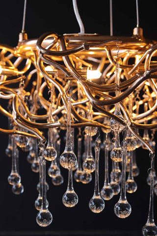 Close-up image of the Rose Gold Droplet Chandelier lit up