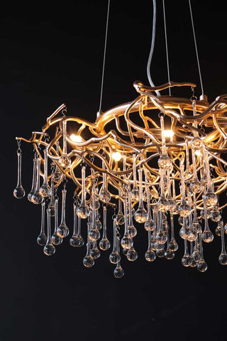 Image showing the Rose Gold Droplet Chandelier lit up