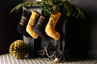 four stockings hung on a fireplace