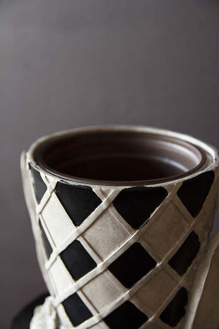 Close-up detail  image of the put holder on the Alice In Wonderland 'Rabbit' Bust Plant Holder without plant inside and on a dark wall background