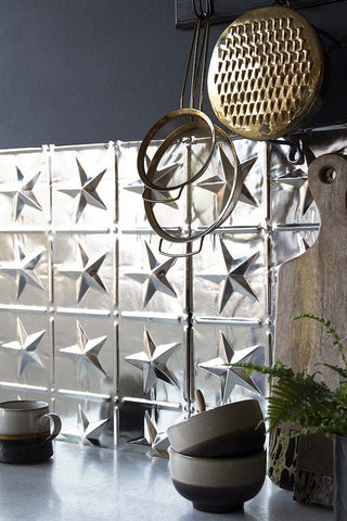 Close up image of a Rockett St George star Tin tile in a kitchen setting. 