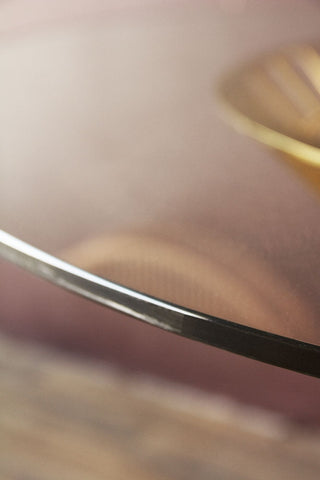 Close-up detail image of the top of the Round Glass Top Dining Table